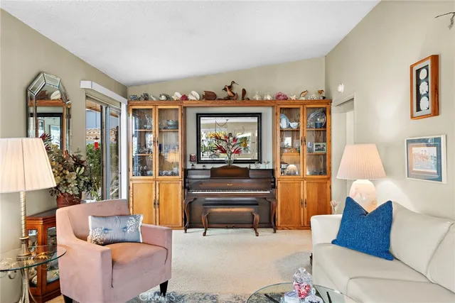 a living room with furniture a couch and paintings on the wall