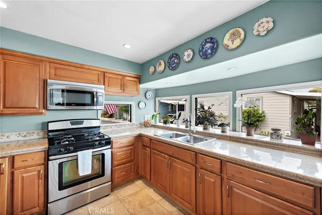 a kitchen with stainless steel appliances granite countertop a stove and a sink