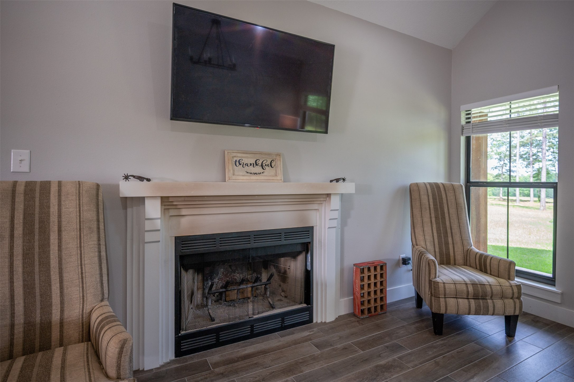 1068 County Road 3200 Colmesneil, TX 75938 - Photo 16 of 43 a living room with furniture a flat screen tv and a fireplace