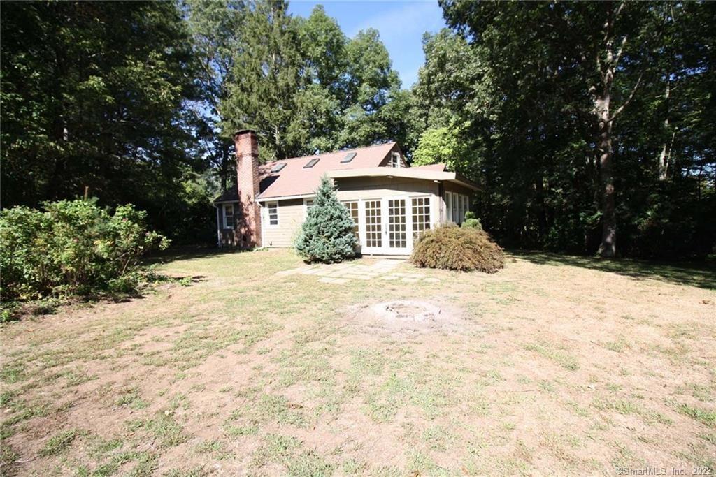 10 Mabel Road East Haddam, CT 06423 - Photo 1 of 1 a front view of a house with a yard covered with trees