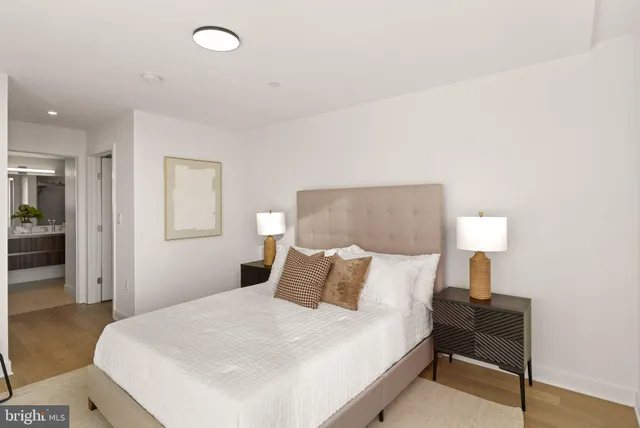 a bedroom with a bed and a lamp