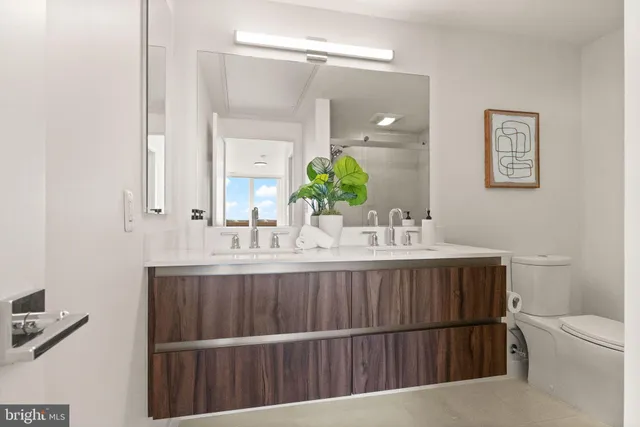 a bathroom with a double vanity sink and a mirror