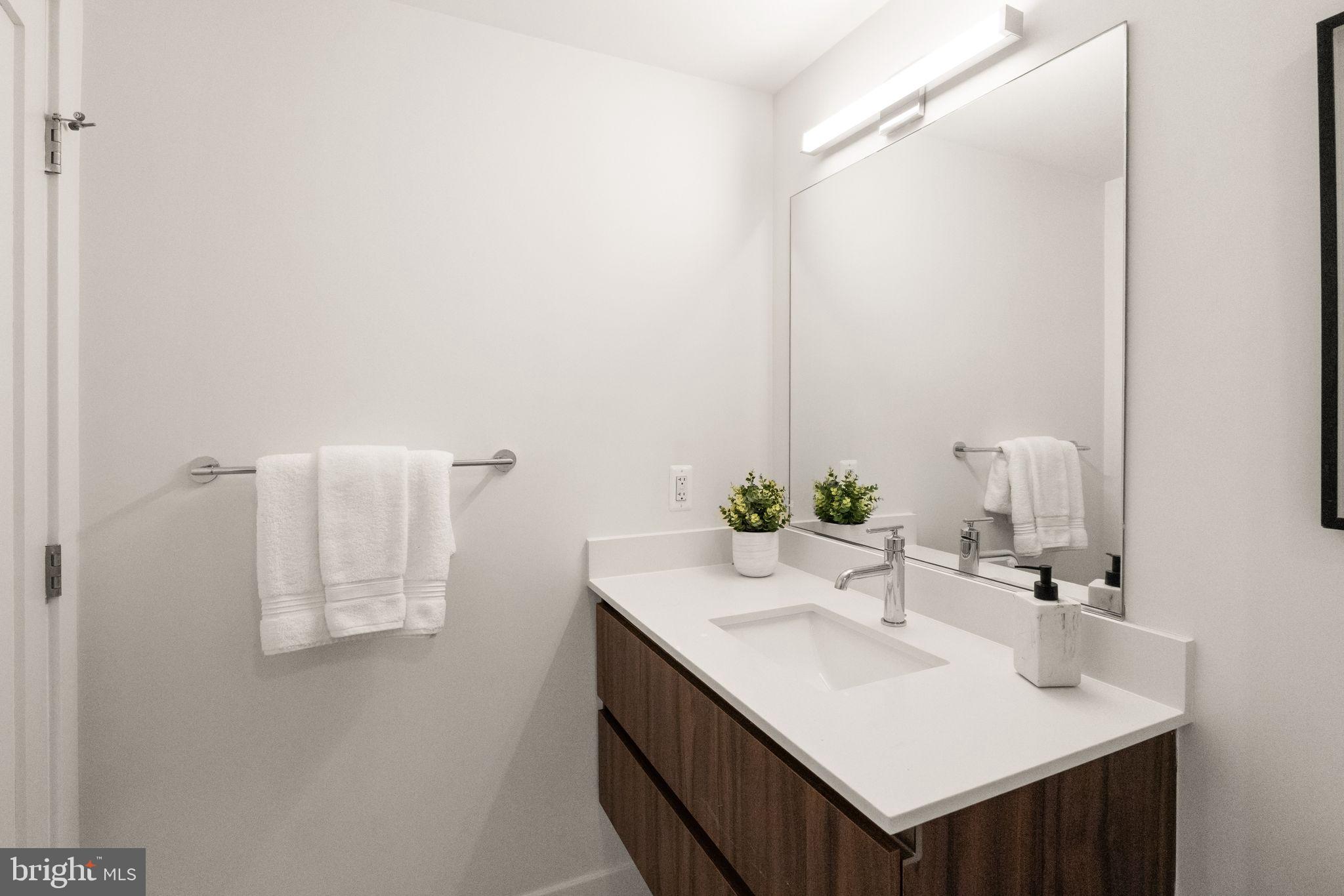 37 L Street Southeast, Unit 1102 Washington, DC 20003 - Photo 19 of 38 a bathroom with a sink and a mirror