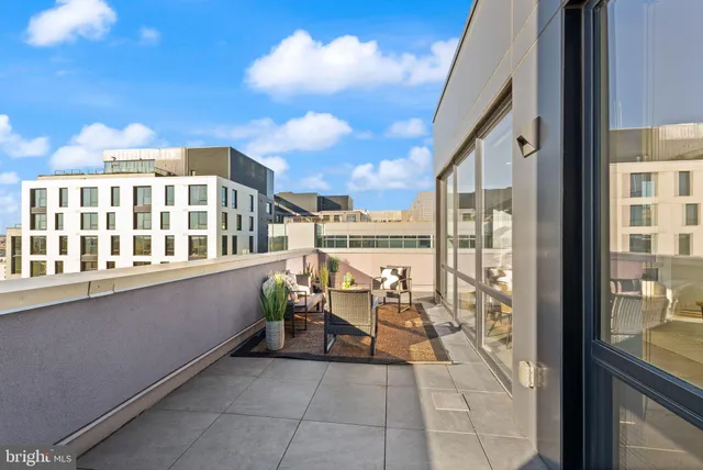 a balcony with furniture and city view