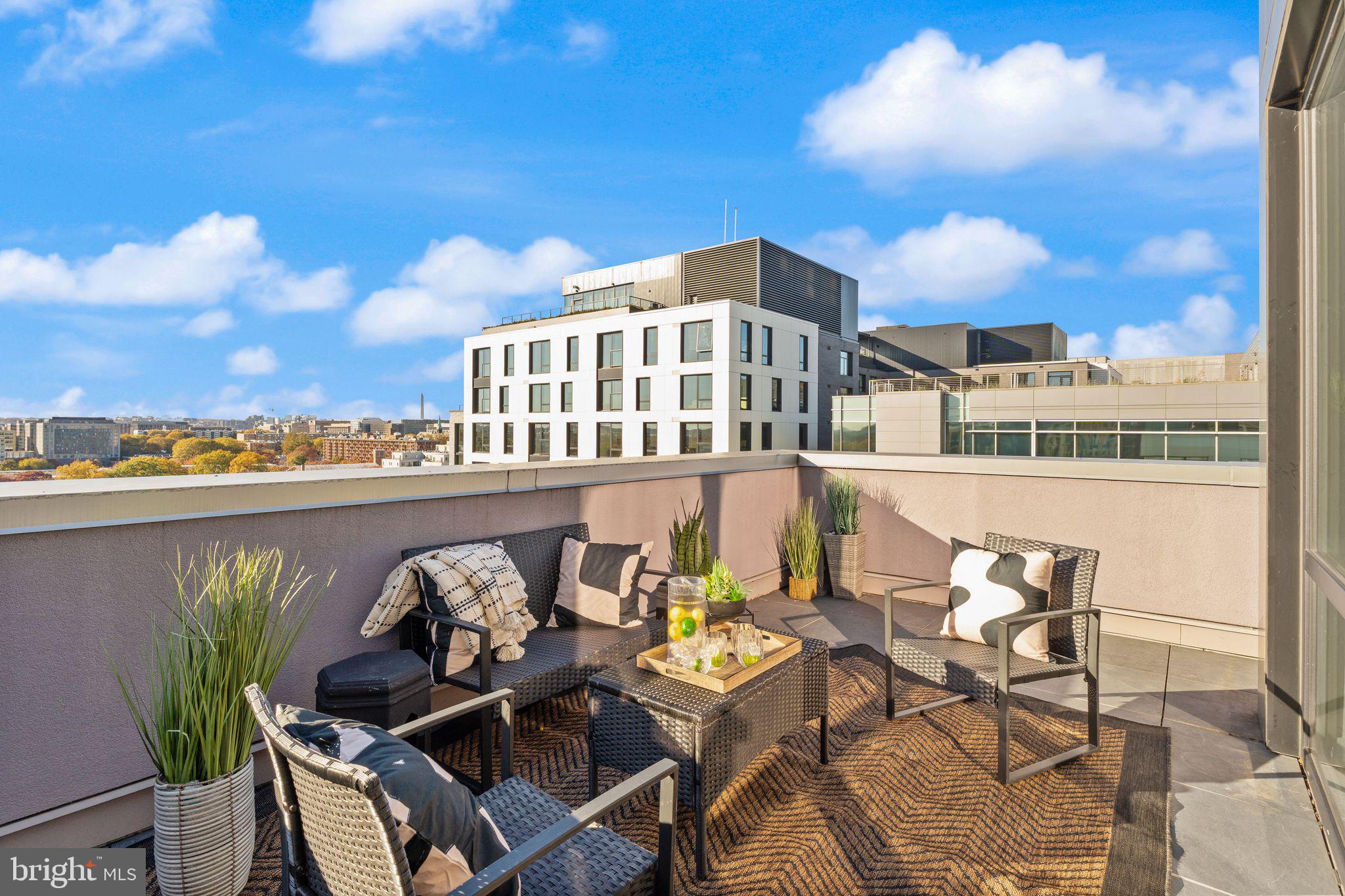 37 L Street Southeast, Unit 1102 Washington, DC 20003 - Photo 22 of 38 a view of a chairs and table in patio