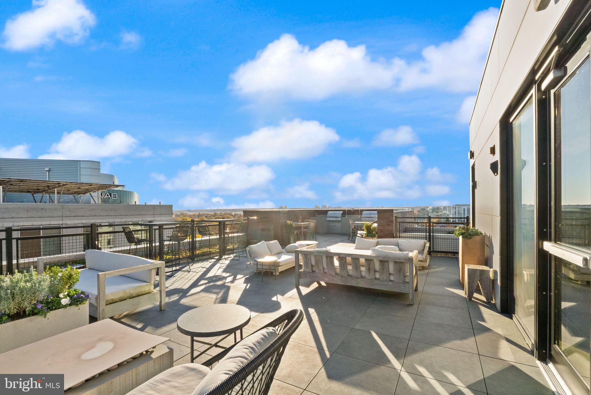 37 L Street Southeast, Unit 1102 Washington, DC 20003 - Photo 29 of 38 a view of a balcony with chairs and a potted plant