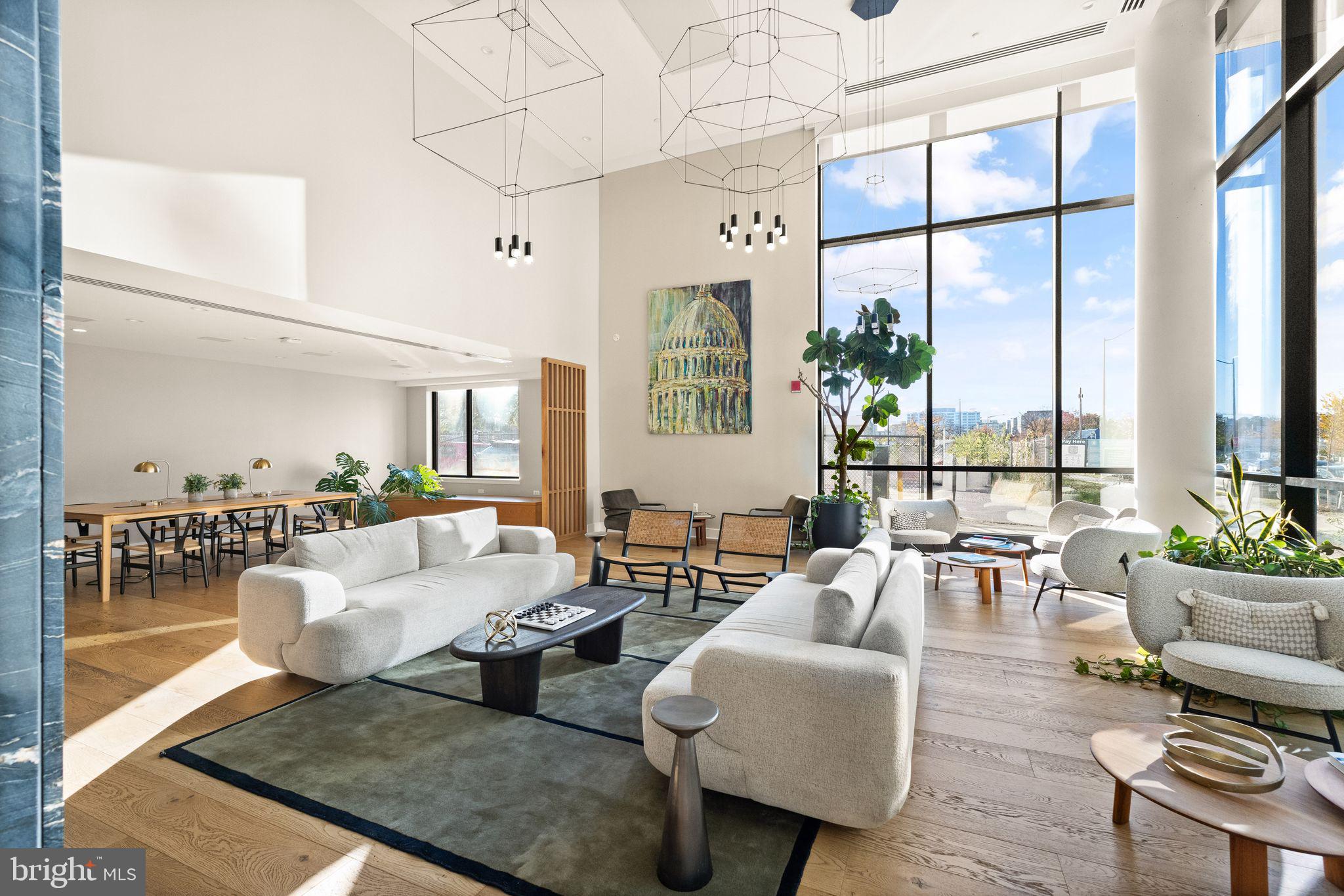 37 L Street Southeast, Unit 1102 Washington, DC 20003 - Photo 33 of 38 a living room with furniture large windows and wooden floor