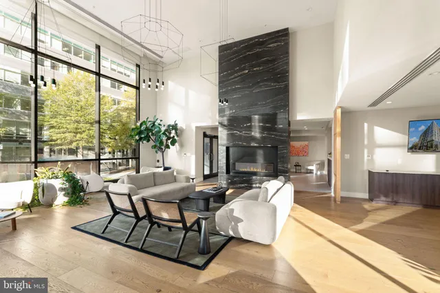 a living room with furniture and a floor to ceiling window