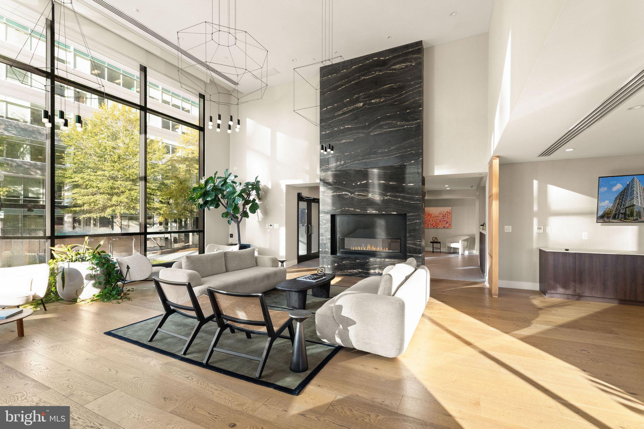 37 L Street Southeast, Unit 1102 Washington, DC 20003 - Photo 35 of 38 a living room with furniture and a floor to ceiling window