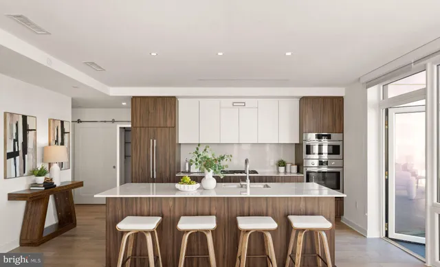 a kitchen with stainless steel appliances granite countertop a refrigerator and a sink