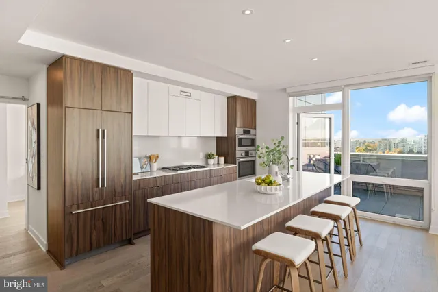 a kitchen with a table chairs refrigerator and window