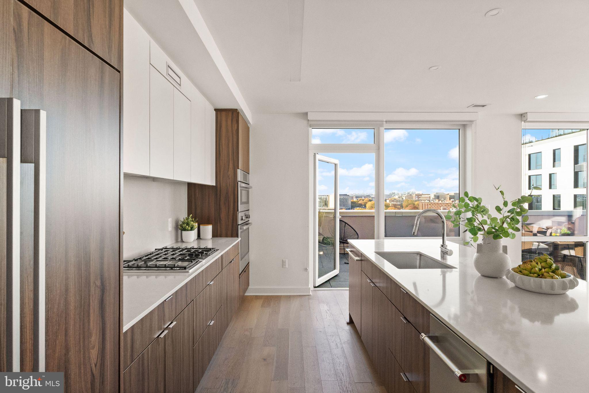 37 L Street Southeast, Unit 1102 Washington, DC 20003 - Photo 7 of 38 a kitchen with counter top space a sink appliances and cabinets