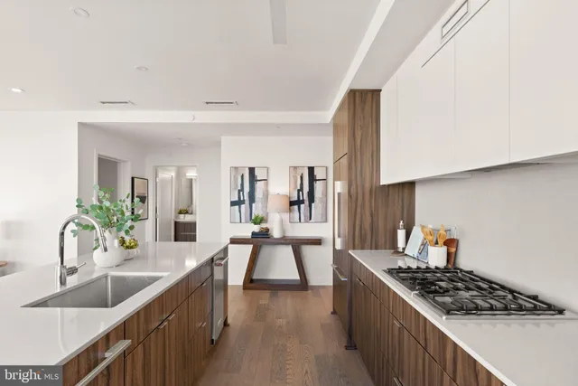 a kitchen with a sink and a stove top oven