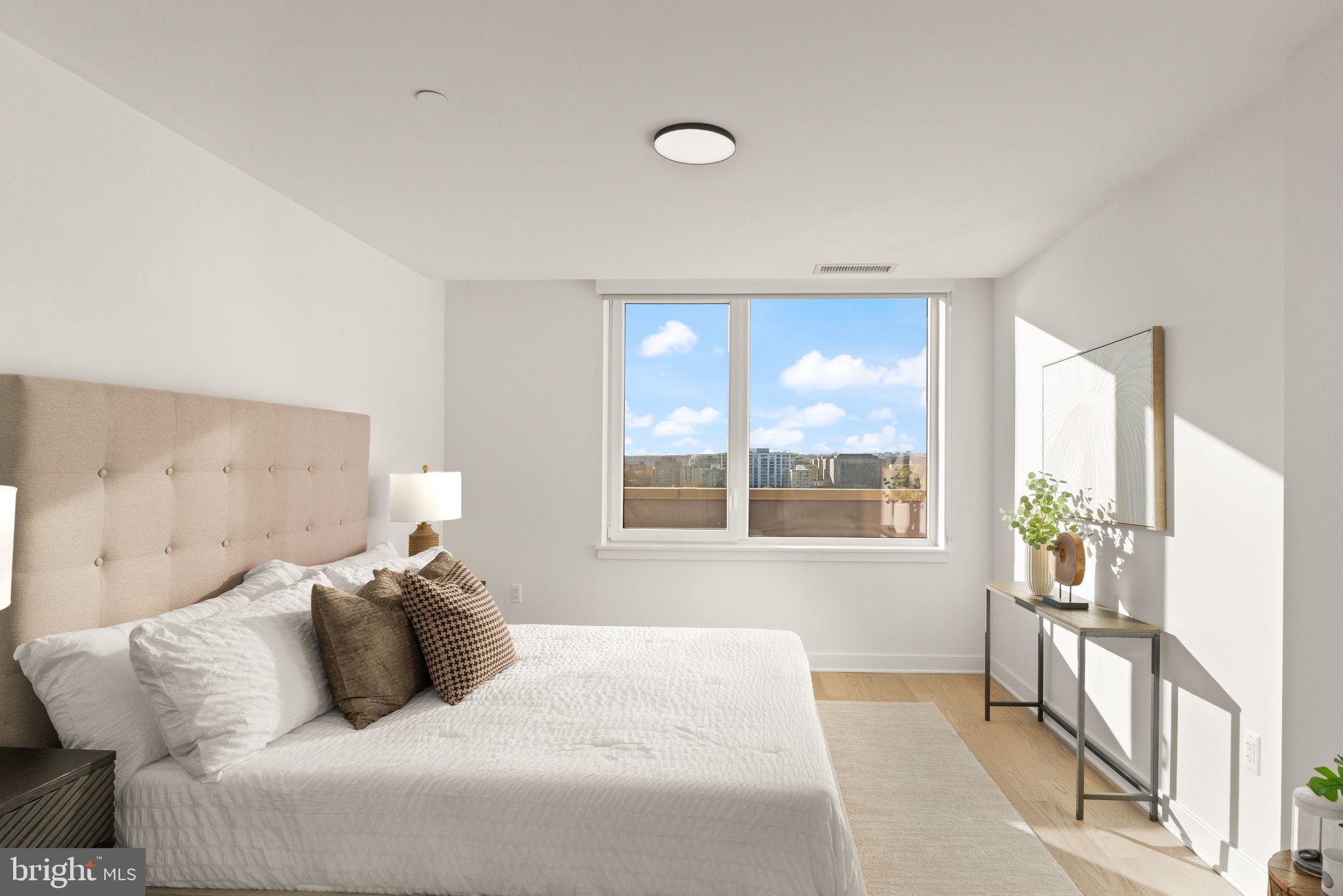 37 L Street Southeast, Unit 1102 Washington, DC 20003 - Photo 10 of 38 a bedroom with a large bed and a large window