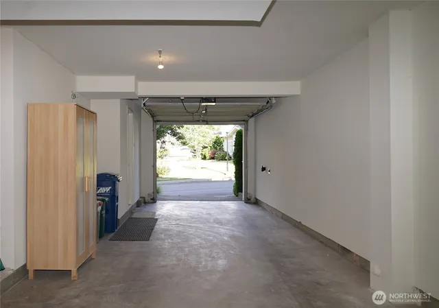 a view of hallway with furniture and a window
