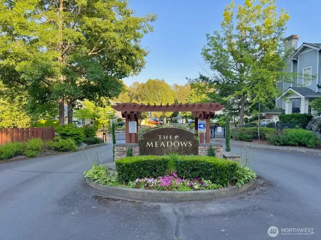 an aerial view of a house with plants and large trees
