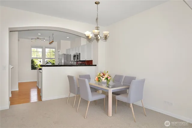 a dining room with furniture a chandelier and a rug