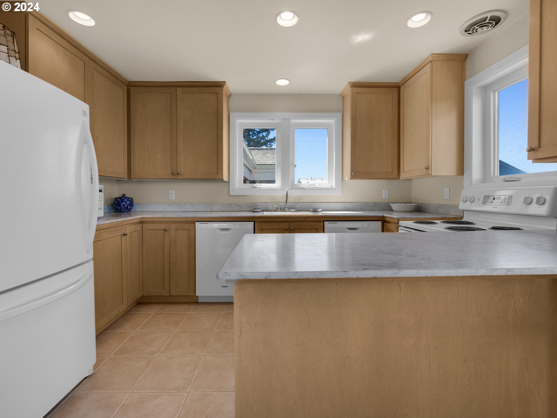 5290 High Ridge Road Gearhart, OR 97138 - Photo 9 of 26 a kitchen with granite countertop a sink a stove and a refrigerator
