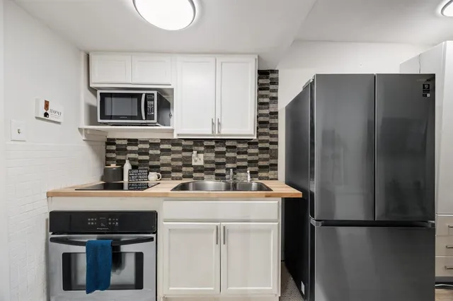 a kitchen with a refrigerator sink and microwave