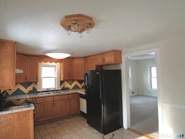 a kitchen with a refrigerator and a sink