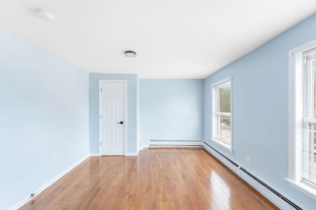 693 Chestnut Street, Unit 2 Kearny, NJ 07032 - Photo 11 of 19 a view of an empty room with wooden floor and a window