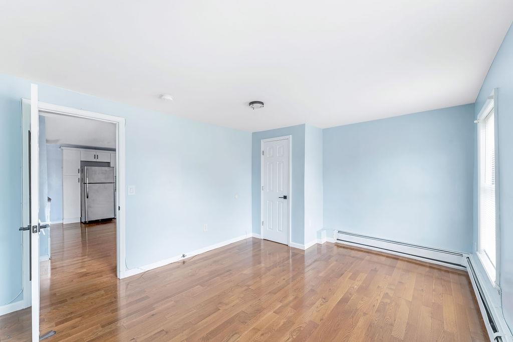693 Chestnut Street, Unit 2 Kearny, NJ 07032 - Photo 12 of 19 a view of empty room with wooden floor and fan