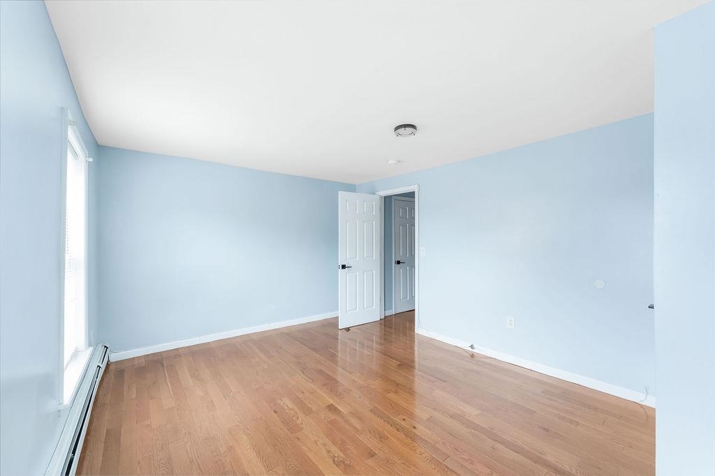 693 Chestnut Street, Unit 2 Kearny, NJ 07032 - Photo 13 of 19 a view of an empty room with wooden floor