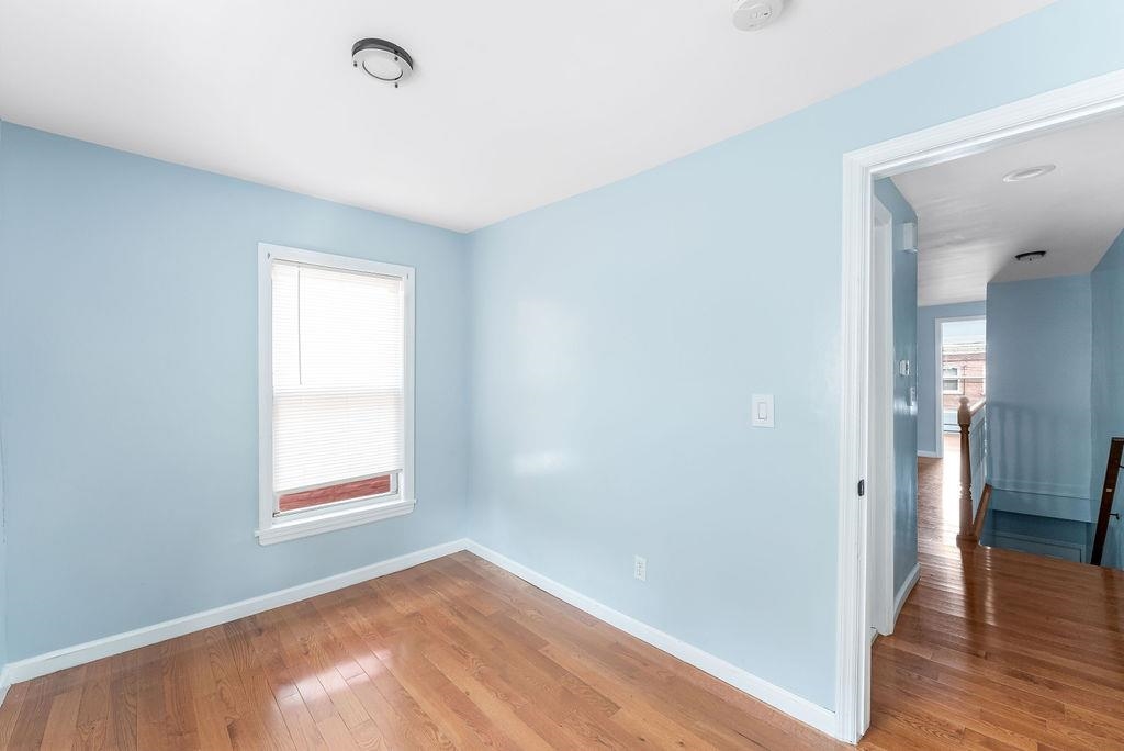 693 Chestnut Street, Unit 2 Kearny, NJ 07032 - Photo 17 of 19 an empty room with wooden floor and a window