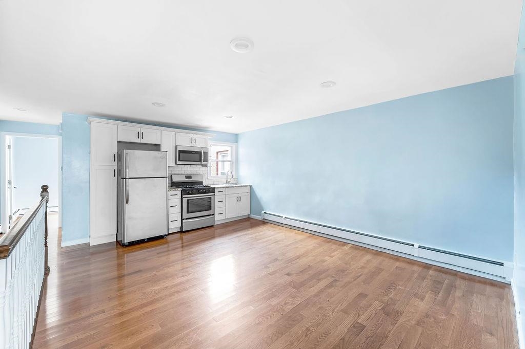 693 Chestnut Street, Unit 2 Kearny, NJ 07032 - Photo 2 of 19 a view of kitchen with wooden floor and electronic appliances