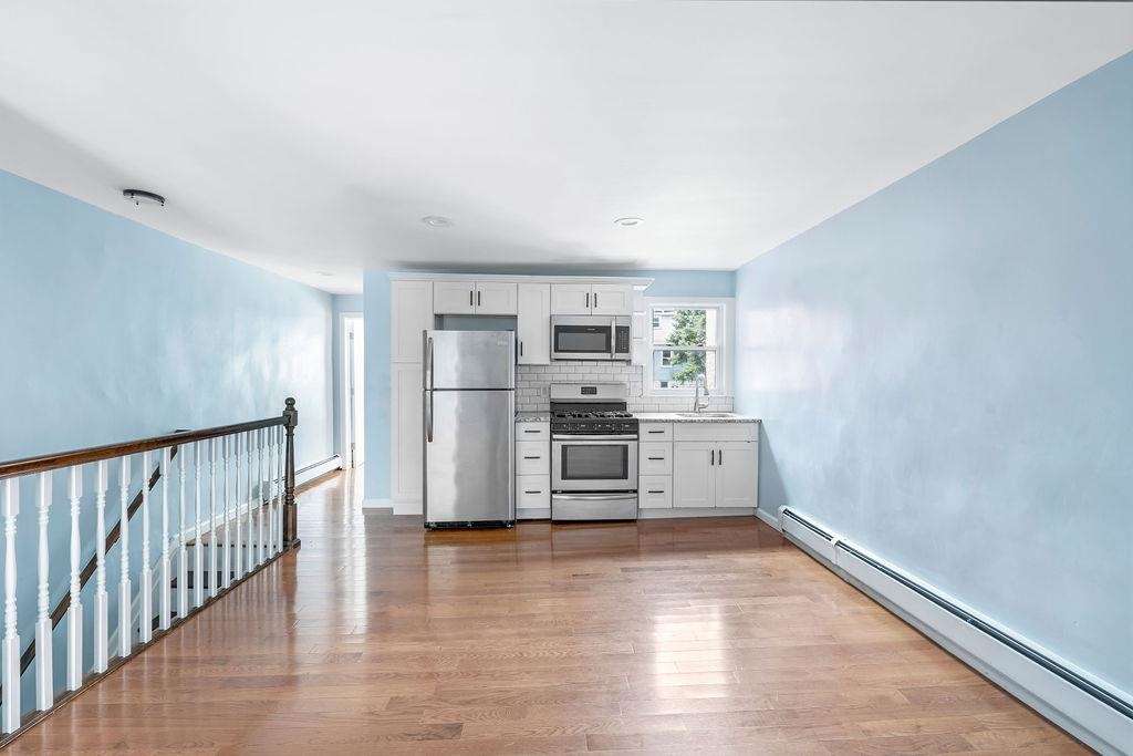 693 Chestnut Street, Unit 2 Kearny, NJ 07032 - Photo 3 of 19 a view of kitchen with cabinets and wooden floor