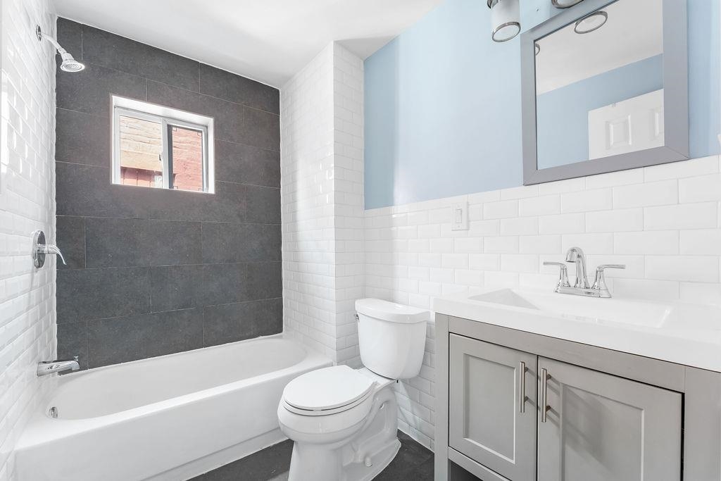 693 Chestnut Street, Unit 2 Kearny, NJ 07032 - Photo 8 of 19 a bathroom with a sink a toilet and a bathtub