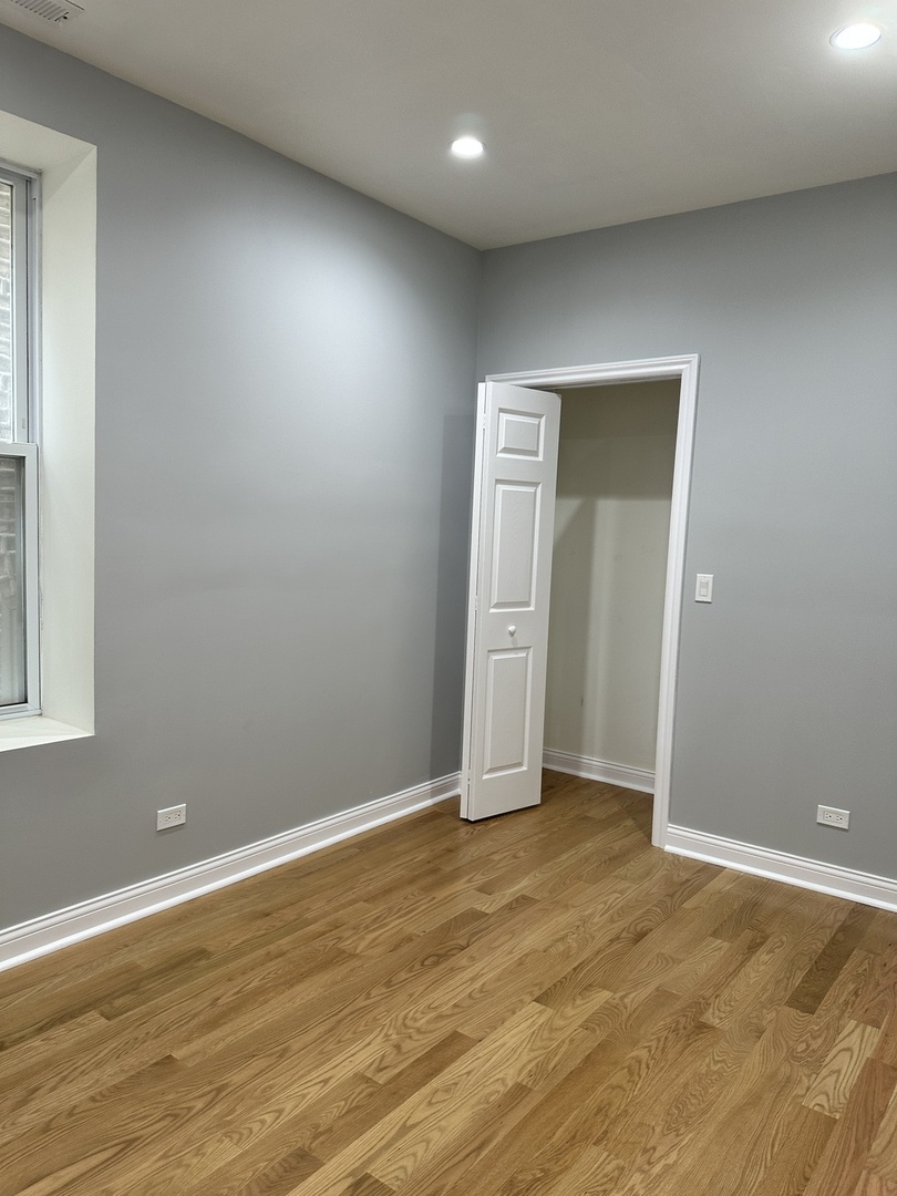 2002 West 21st Place, Unit GDN Chicago, IL 60608 - Photo 7 of 9 an empty room with wooden floor and windows
