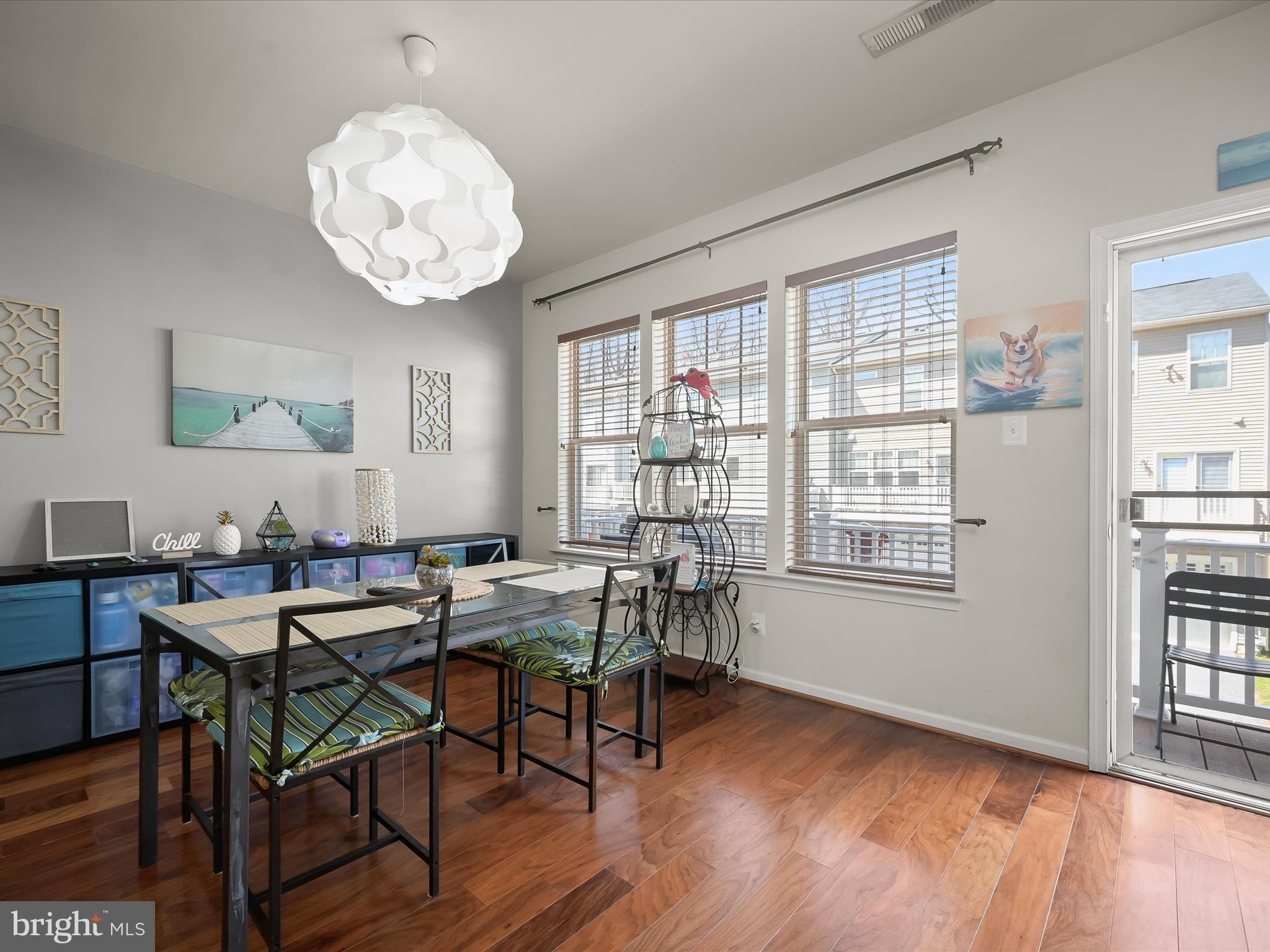 1117 Red Hawk Way Severn, MD 21144 - Photo 14 of 39 a view of a dining room with furniture wooden floor and a chandelier