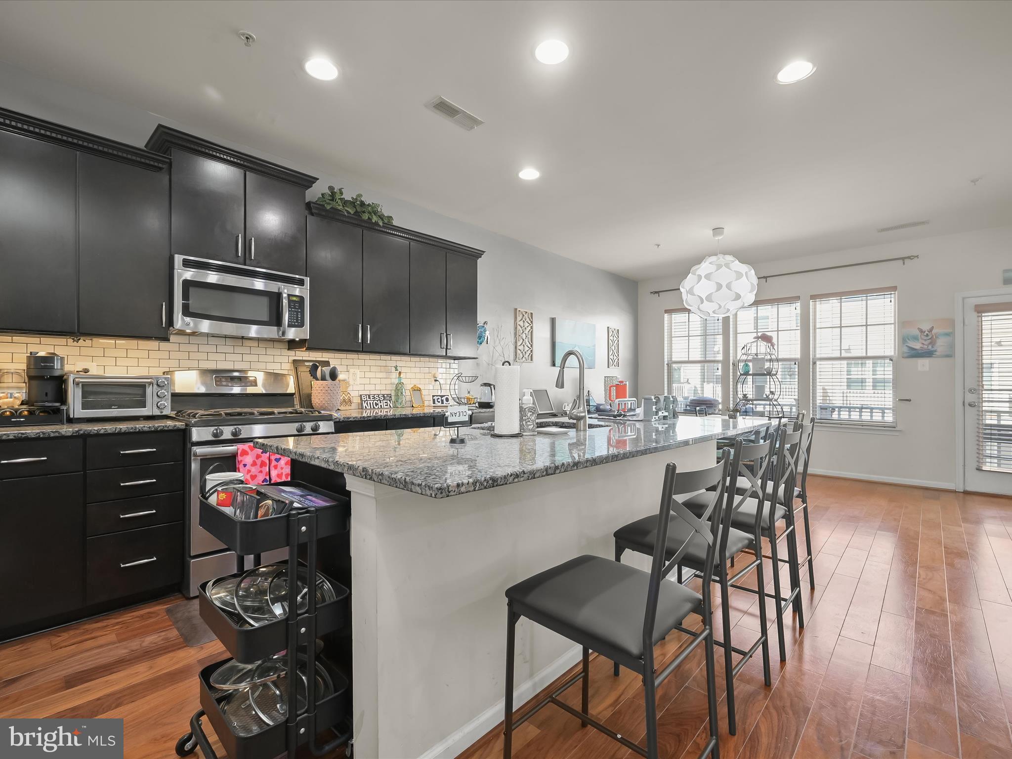 1117 Red Hawk Way Severn, MD 21144 - Photo 9 of 39 a kitchen with stainless steel appliances granite countertop a stove top oven a sink dishwasher and cabinets with wooden floor