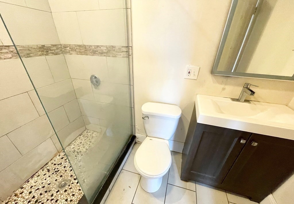 92 L Street, Unit 2 Boston, MA 02127 - Photo 13 of 15 a bathroom with a sink toilet and shower