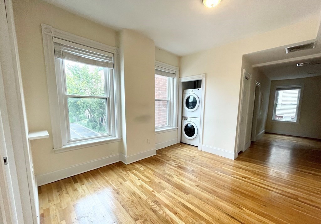92 L Street, Unit 2 Boston, MA 02127 - Photo 4 of 15 a view of an empty room with window and wooden floor