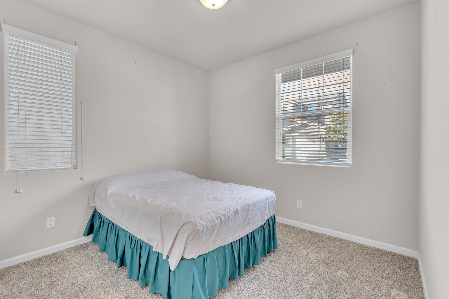 3532 Journey Way Clovis, CA 93619 - Photo 12 of 24 a bedroom with a bed and a window