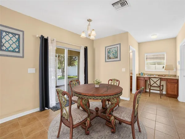 a dining room with furniture and window