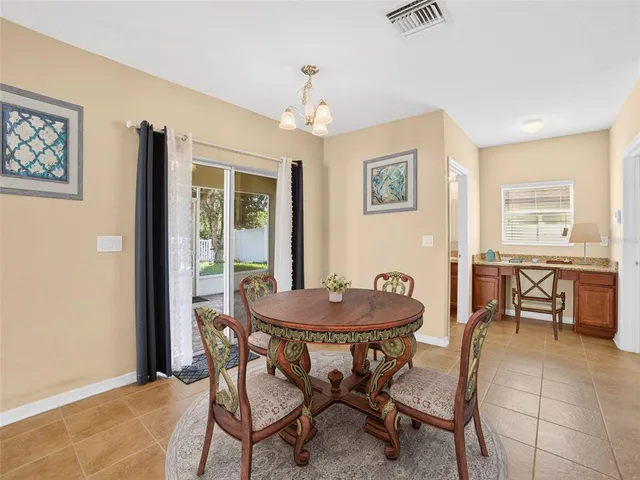 a dining room with furniture and window