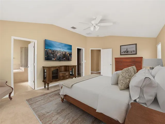 a bedroom with a bed and windows