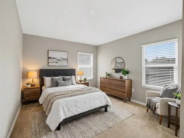 a bedroom with a bed and windows