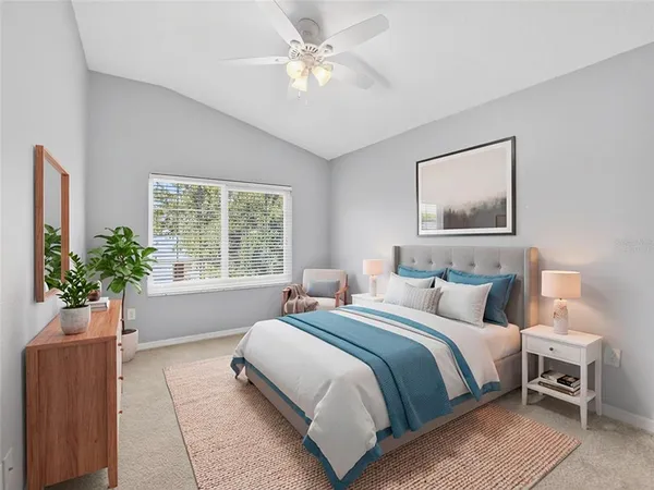 a bedroom with a large bed and a chandelier