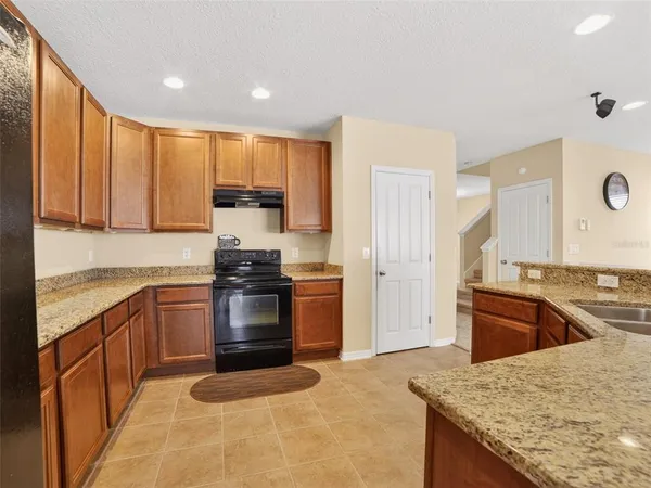 a kitchen with granite countertop stainless steel appliances and wooden cabinets