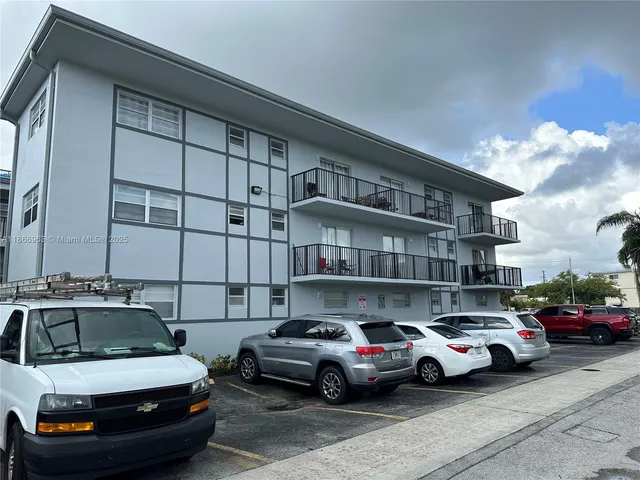 a view of cars parked in front of a building