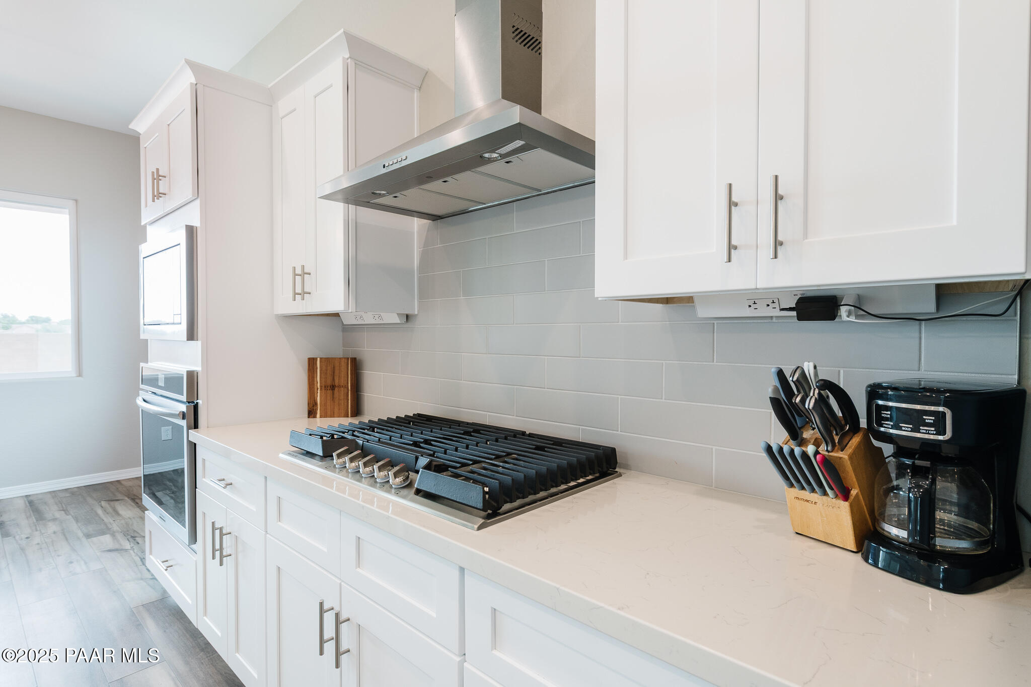 7091 Turquoise Street Prescott, AZ 86305 - Photo 9 of 27 a kitchen with stainless steel appliances granite countertop a stove a sink and a white cabinets