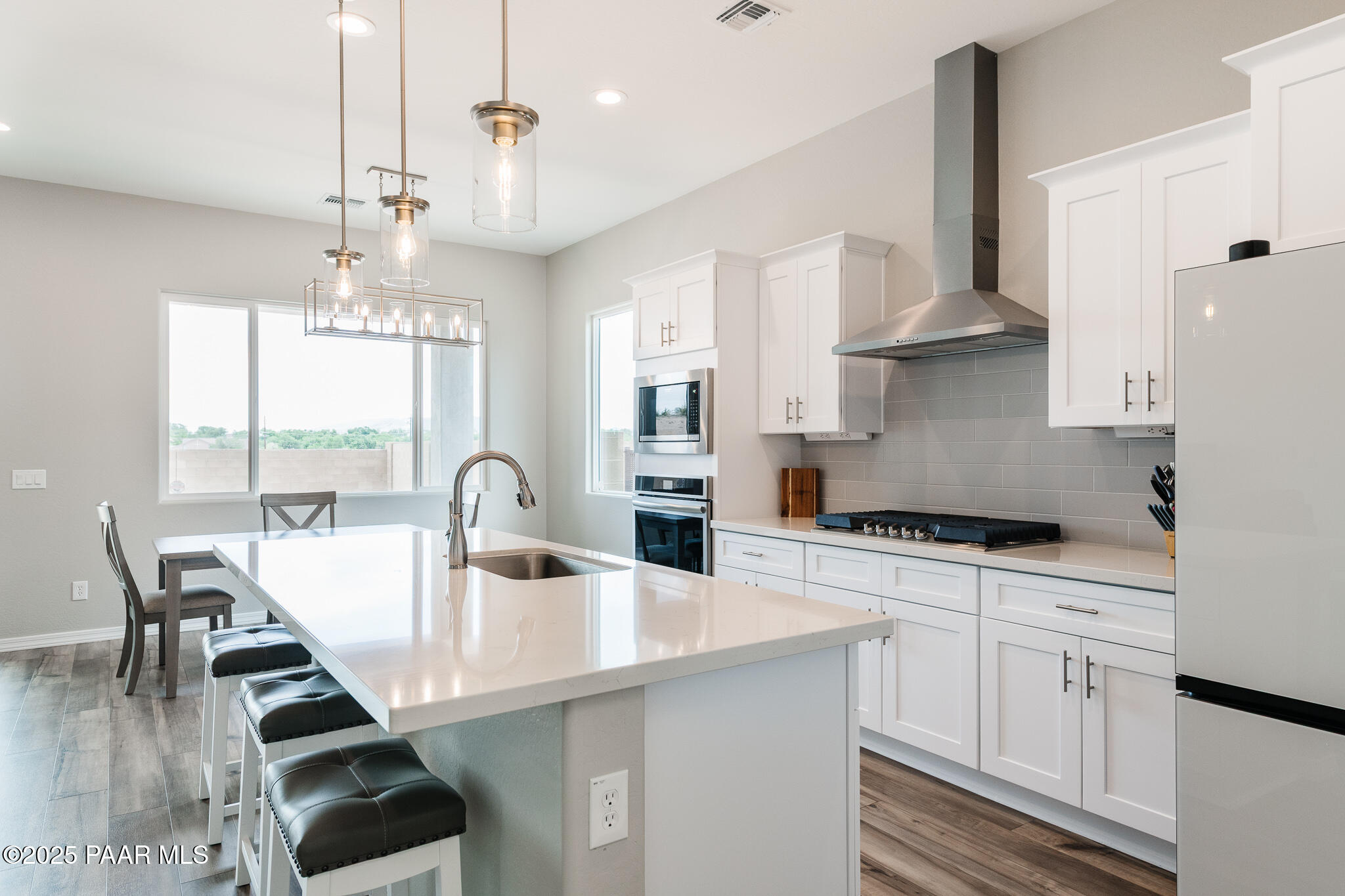 7091 Turquoise Street Prescott, AZ 86305 - Photo 10 of 27 a kitchen with stainless steel appliances a table chairs and a stove