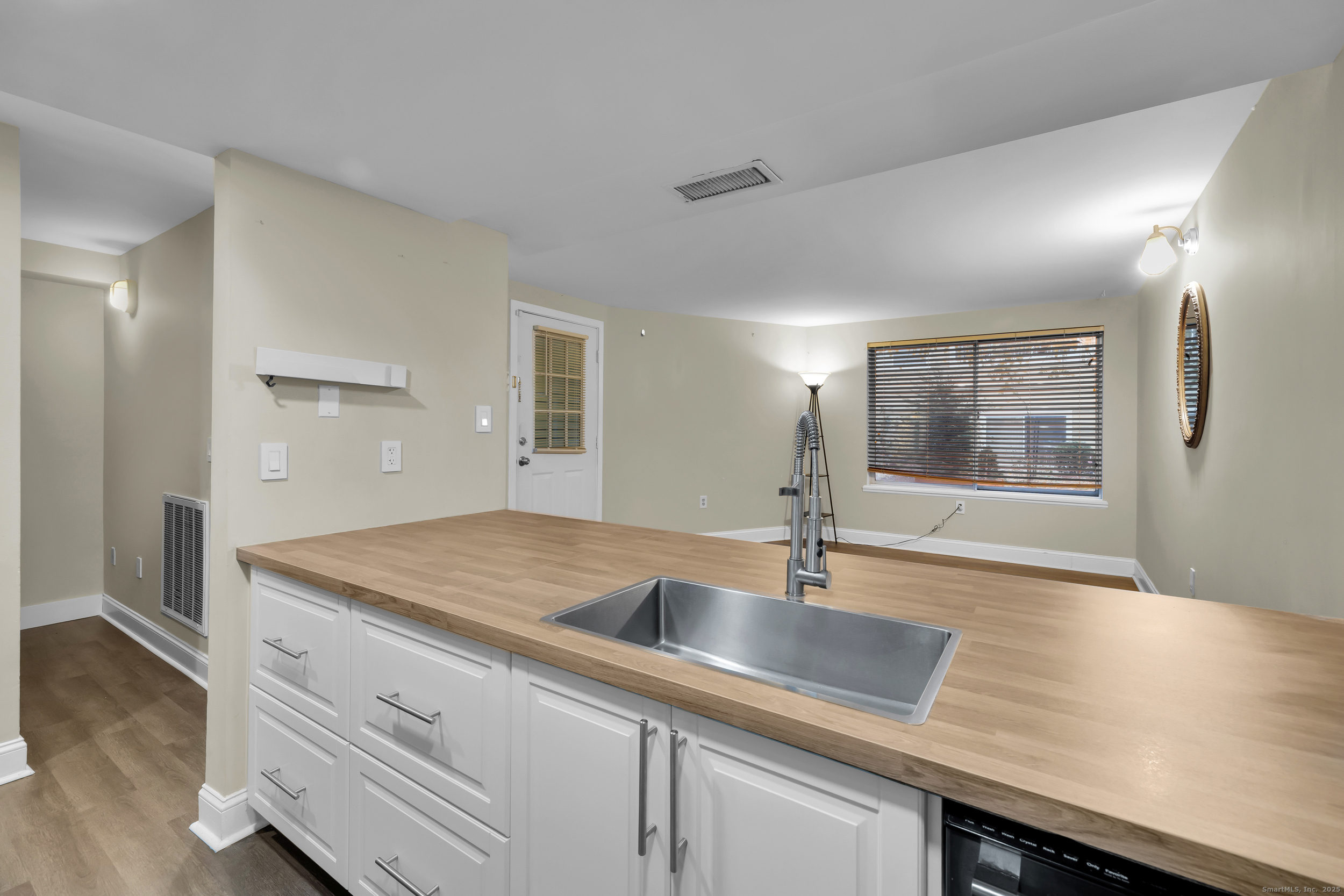 1 Front Street, Unit 113 New Haven, CT 06513 - Photo 13 of 22 a hallway with sink and mirror