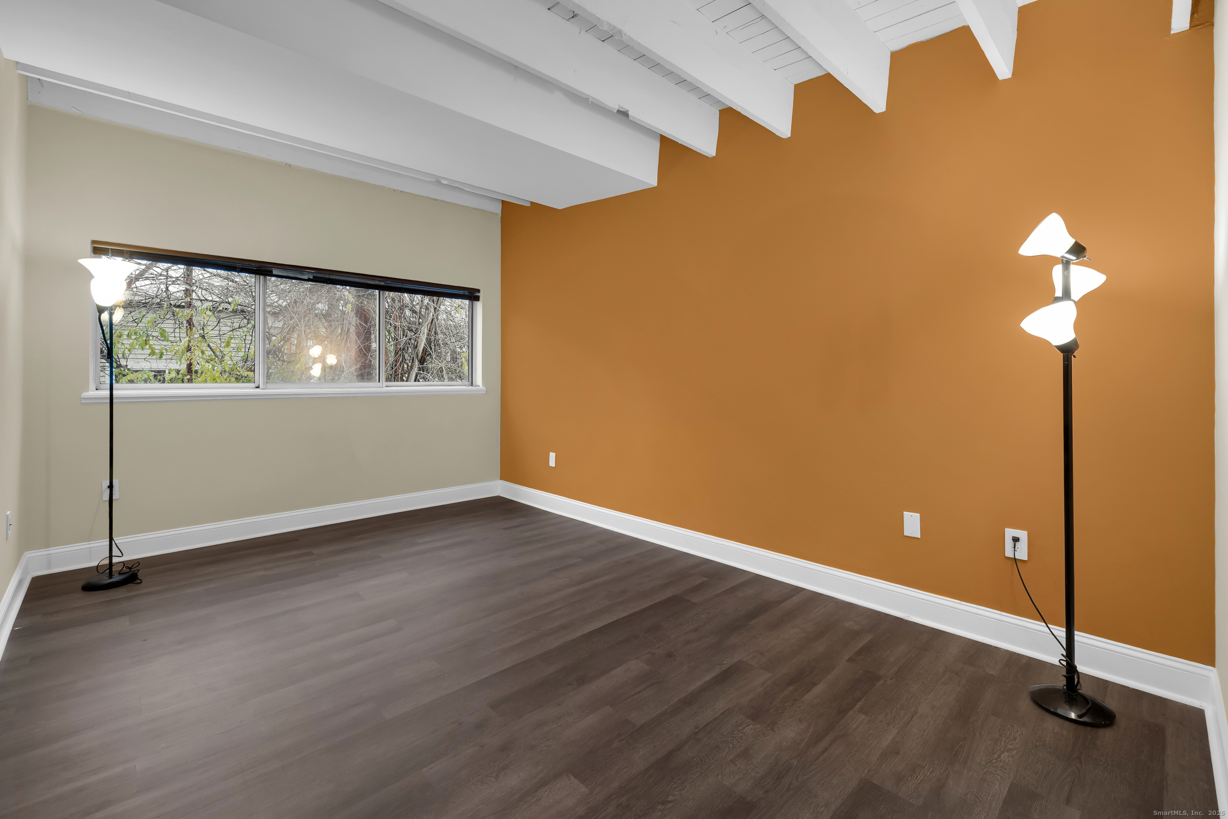 1 Front Street, Unit 113 New Haven, CT 06513 - Photo 18 of 22 an empty room with wooden floor and windows