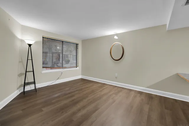 a view of room with wooden floor and window