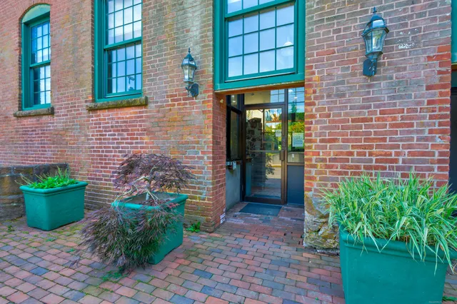 a view of a backyard of the house with potted plants